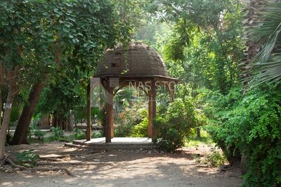 Circular wooden kiosk in Orman Garden, surrounded by trees