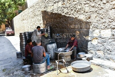Group of craftsmen making aluminum utensils