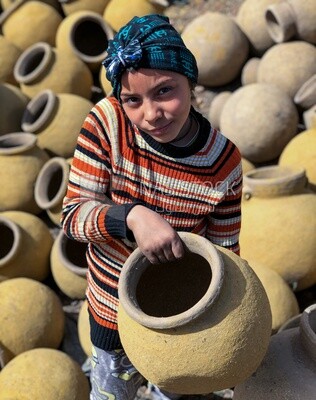 An Egyptian girl holding a pottery pot