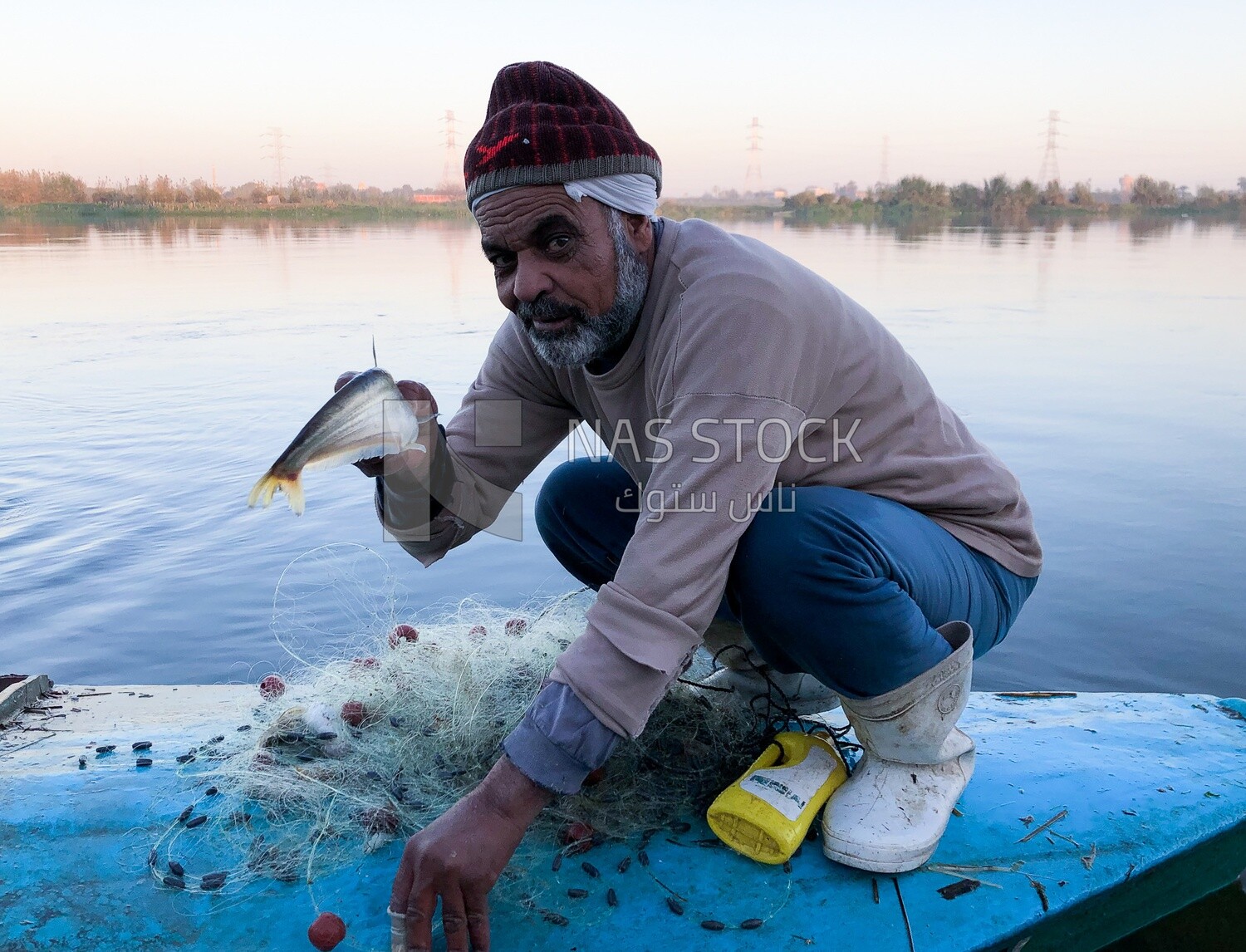 An Egyptian fisherman with a fish he caught