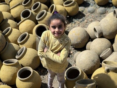 An Egyptian girl holding a pottery pot