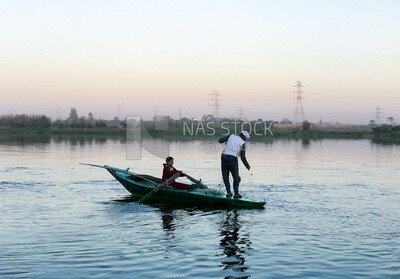 Boat with fishermen in the Nile River catching fish
