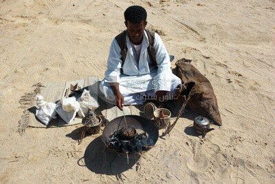 Bedouin man in the desert sitting and cooking