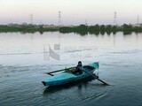 An Egyptian child riding a fishing boat in the Nile River