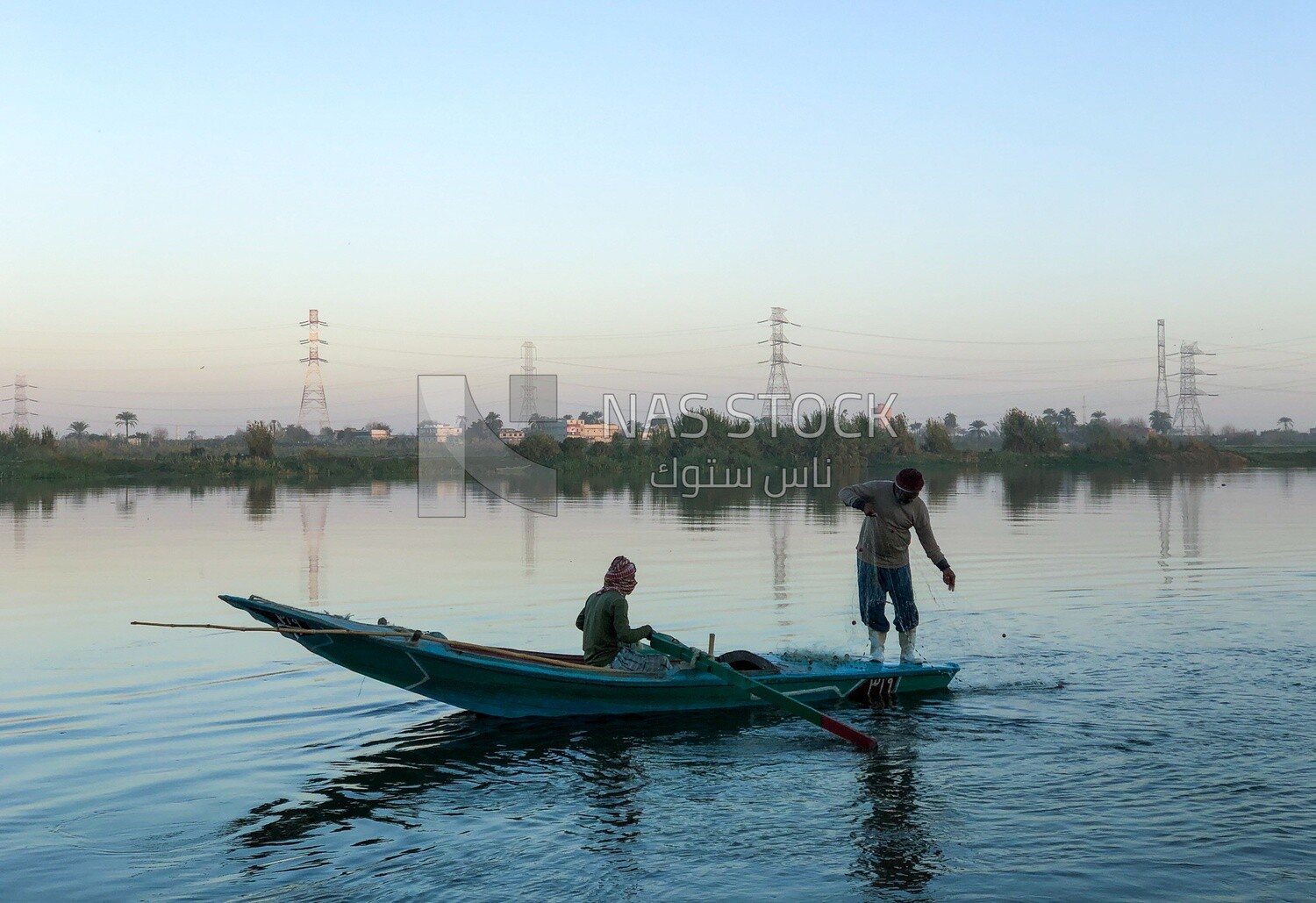 Boat with fishermen in the Nile River catching fish