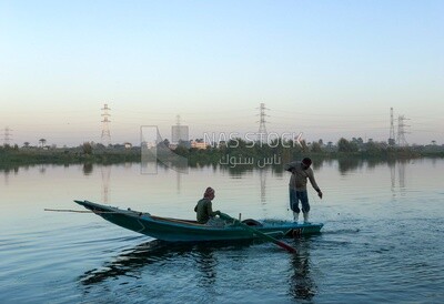 Boat with fishermen in the Nile River catching fish