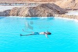 Guy swims in the salt lake in Siwa Oasis, Egypt