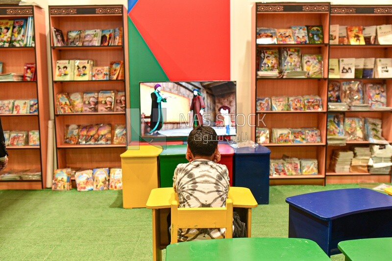 Scene of a child watching cartoons at the Children's Book Fair