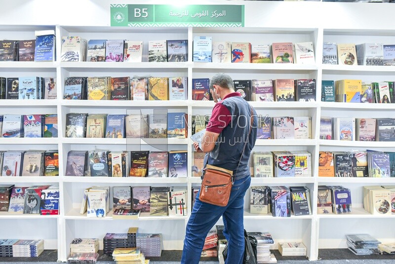 Scene of a man browsing books at a book fair