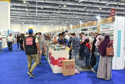 People visiting a book booth at a book fair