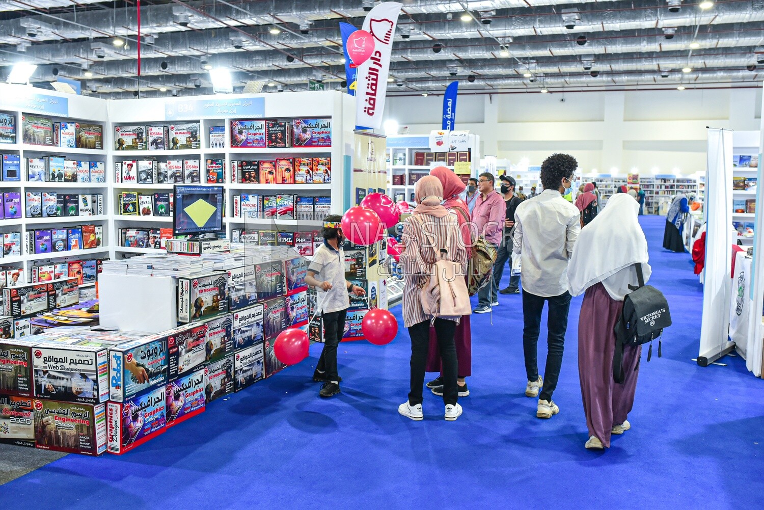 Girls distributing balloons in the Cairo Book Fair