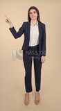 Photo of a businesswoman standing and pointing, meeting at the workplace, discussing work tasks, taking notes on the board