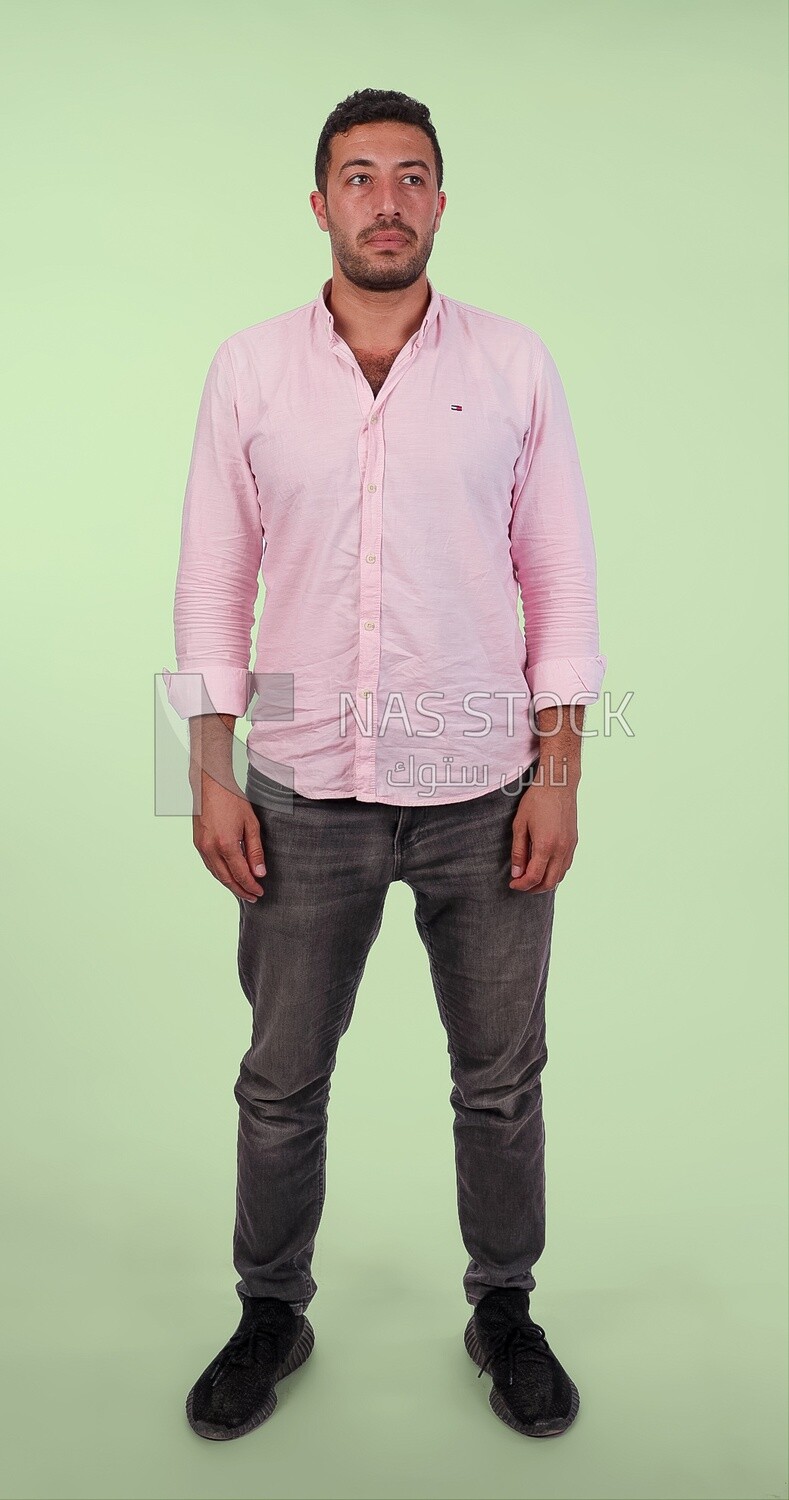 Photo Of Handsome man Standing, Smiling Man, Wearing Casual Clothes Posing In a Light Room Interior, Smiling At the Camera, looking away