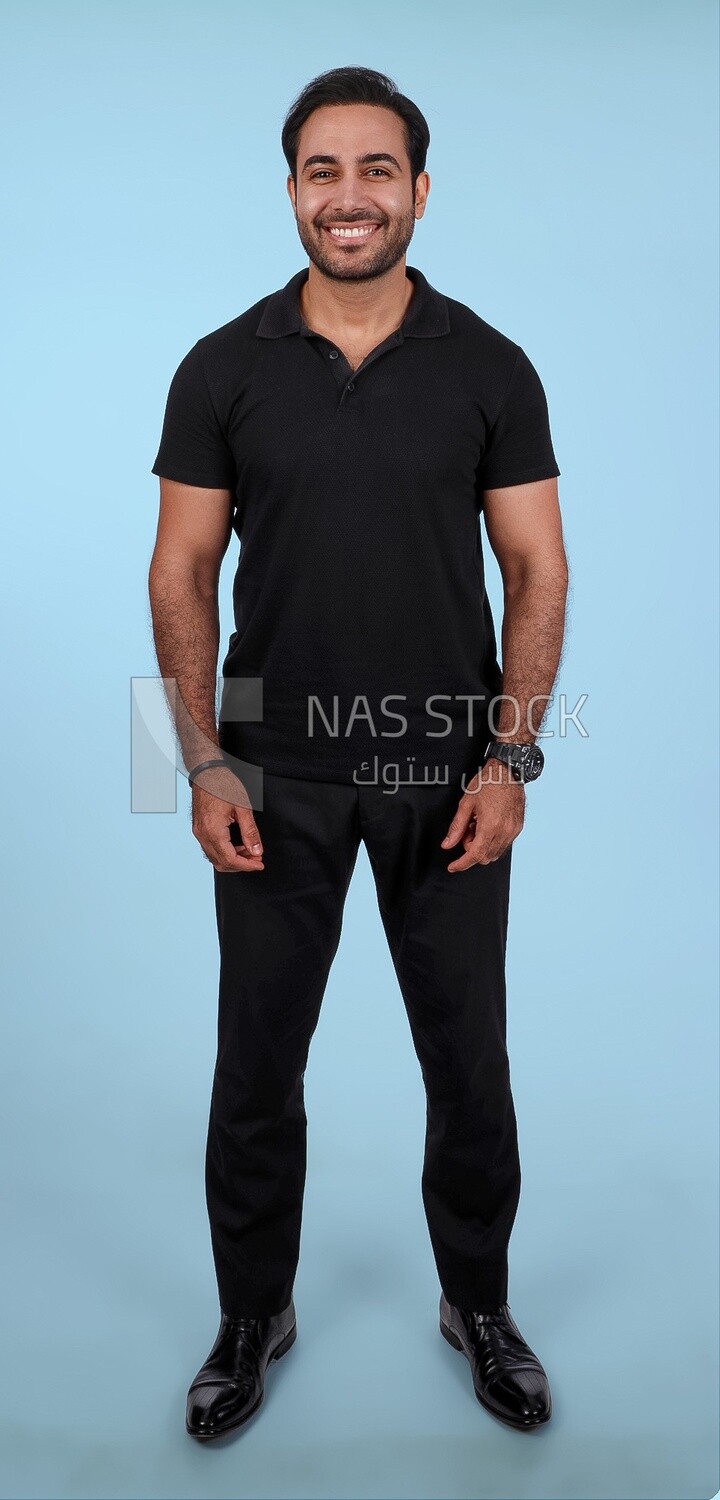 Photo Of Handsome man Standing, Smiling Man, Wearing Casual Clothes Posing In a Light Room Interior, Smiling At the Camera, looking away