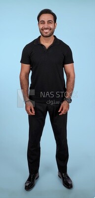 Photo Of Handsome man Standing, Smiling Man, Wearing Casual Clothes Posing In a Light Room Interior, Smiling At the Camera, looking away