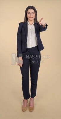 Photo of a businesswoman standing and pointing, meeting at the workplace, discussing work tasks, taking notes on the board