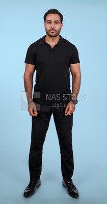 Photo Of Handsome man Standing, Smiling Man, Wearing Casual Clothes Posing In a Light Room Interior, Smiling At the Camera, looking away