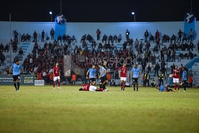 Two injured soccer players on the field