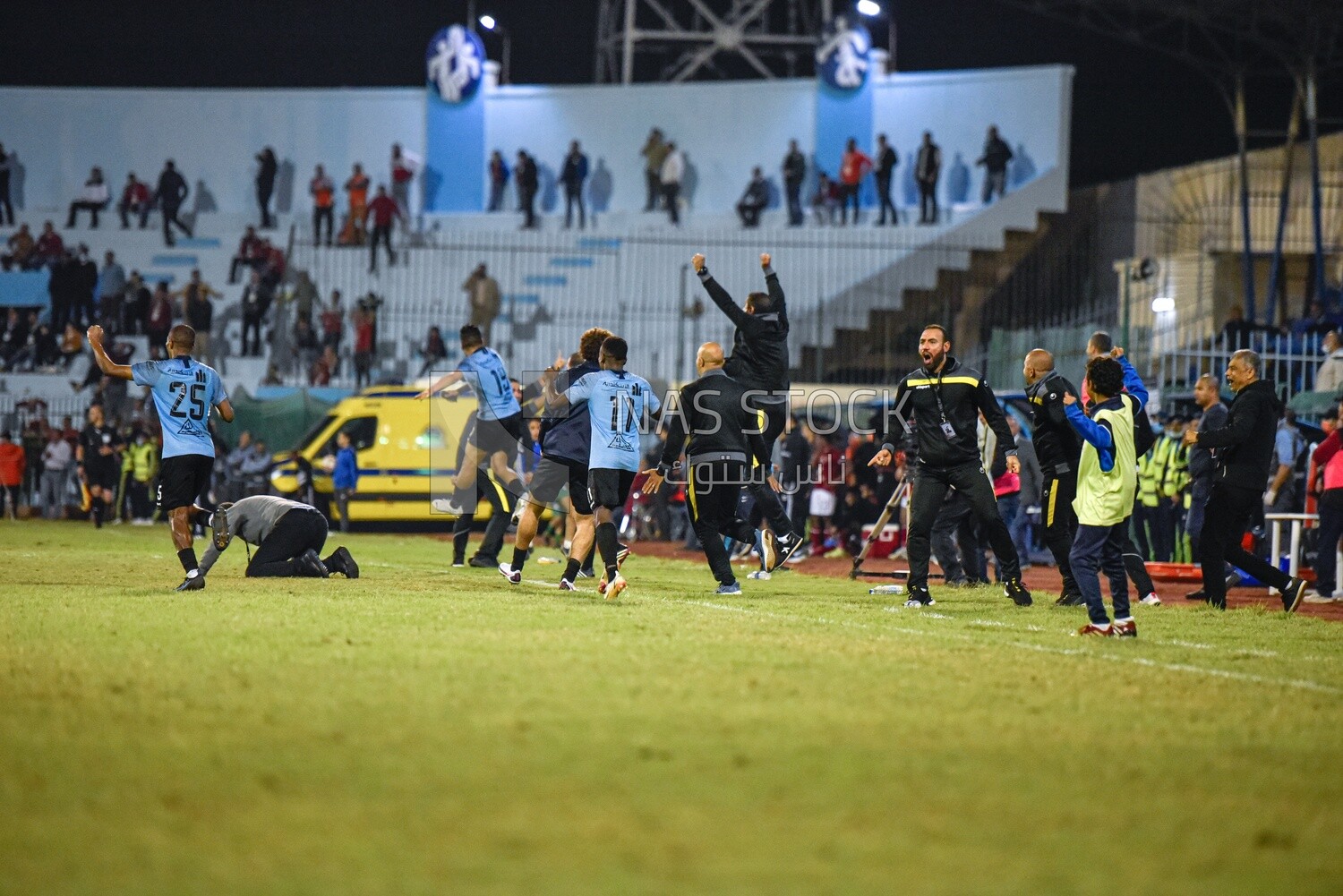 Football team members celebrate winning the match