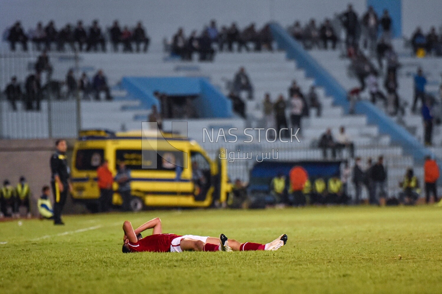Football player resting on the field after the match
