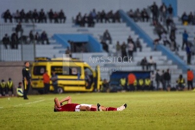 Football player resting on the field after the match