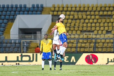 Two players kick the ball with their heads