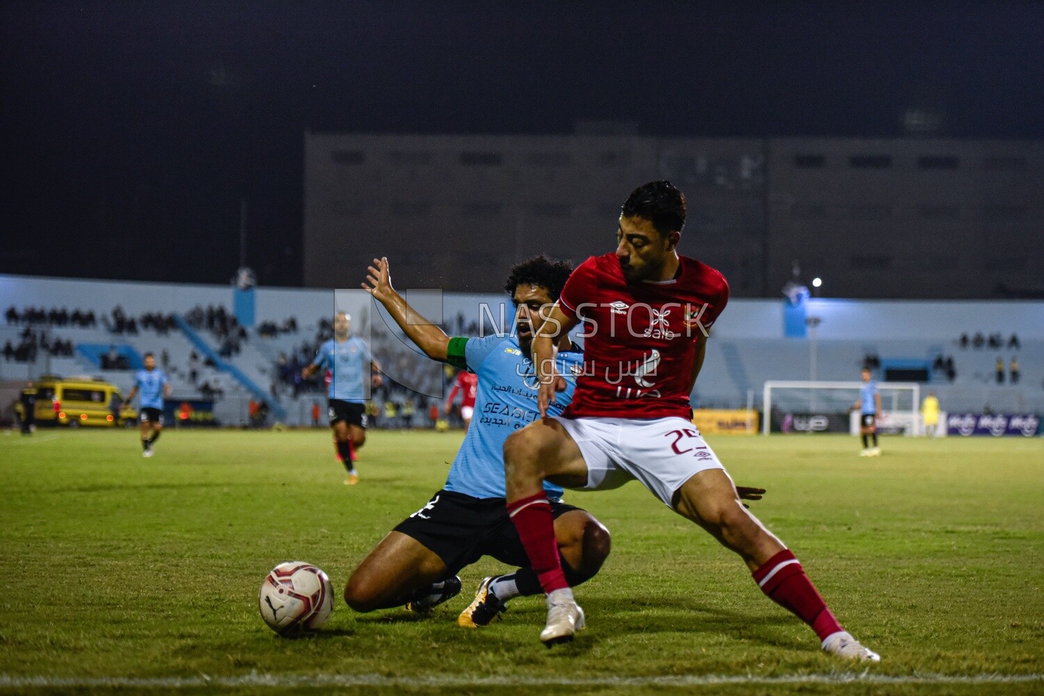 Two soccer players fighting for the ball