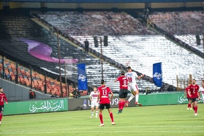 Two players kick the ball with their heads