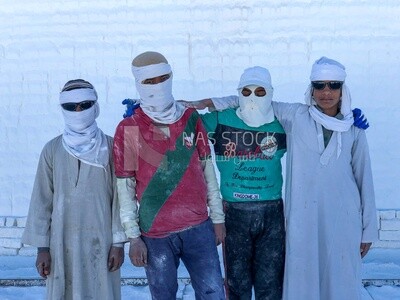 Boys working and learning to make white bricks