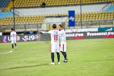 Scene of two football players conferring on the field