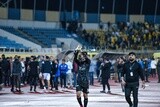 Goalkeeper takes off his glove after the match