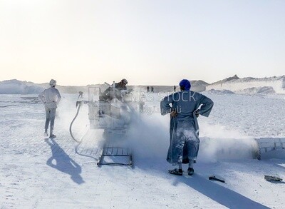 A scene of a group of craftsmen in one of the stages of making white bricks
