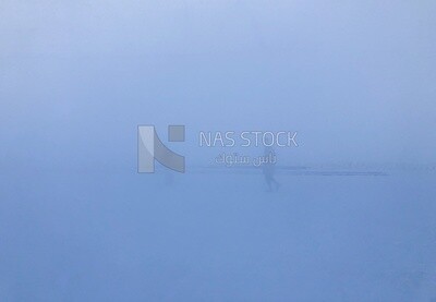 A scene of thick fog covering the place and the workers