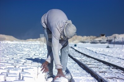 An Egyptian craftsman arranging the white bricks