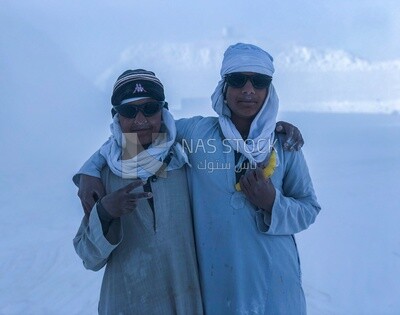 Two sons working with their father in the white brick industry