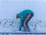 Boy working and learning to make white bricks