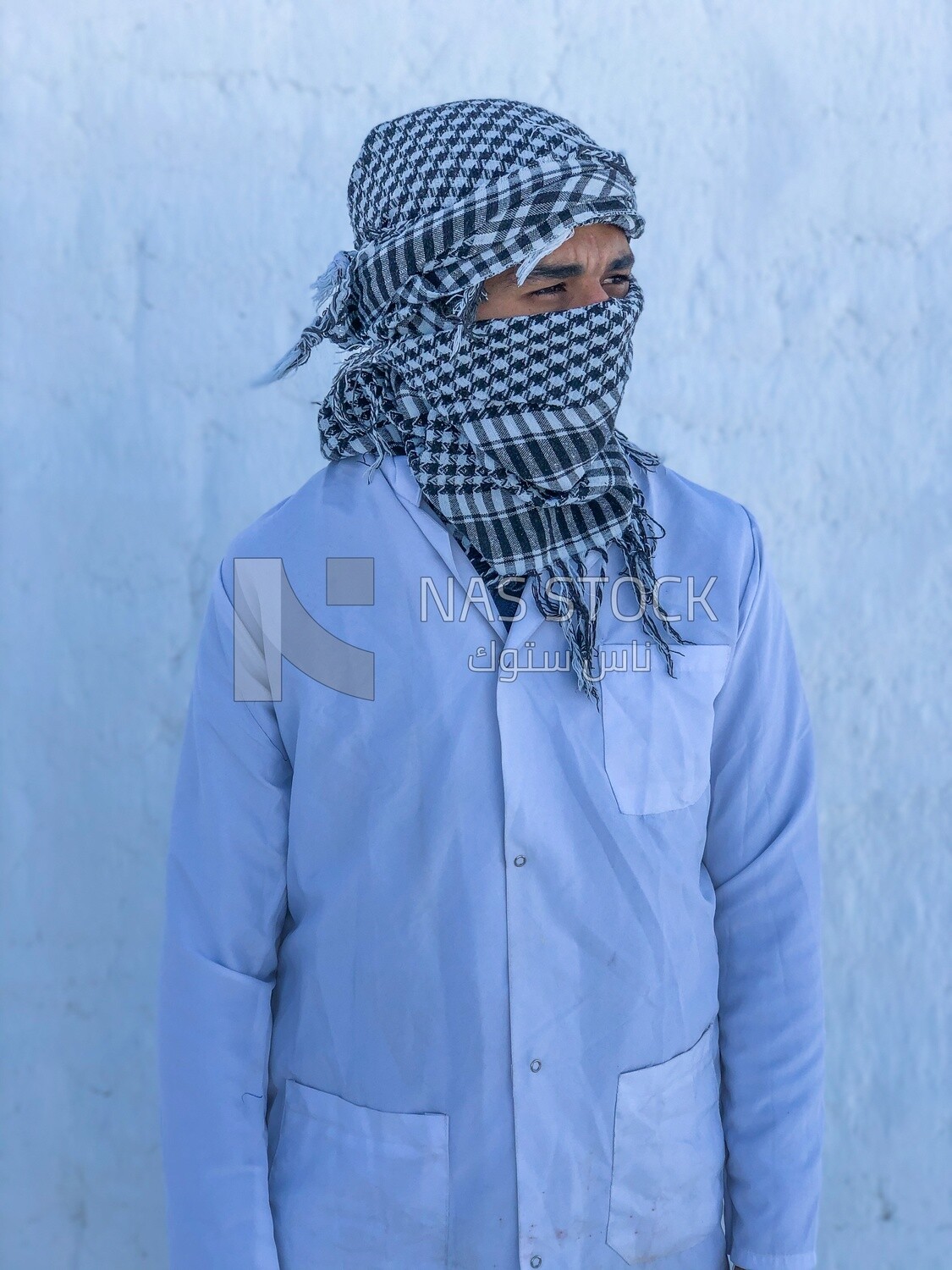 An Egyptian worker covers a face with brick dust from the brick industry