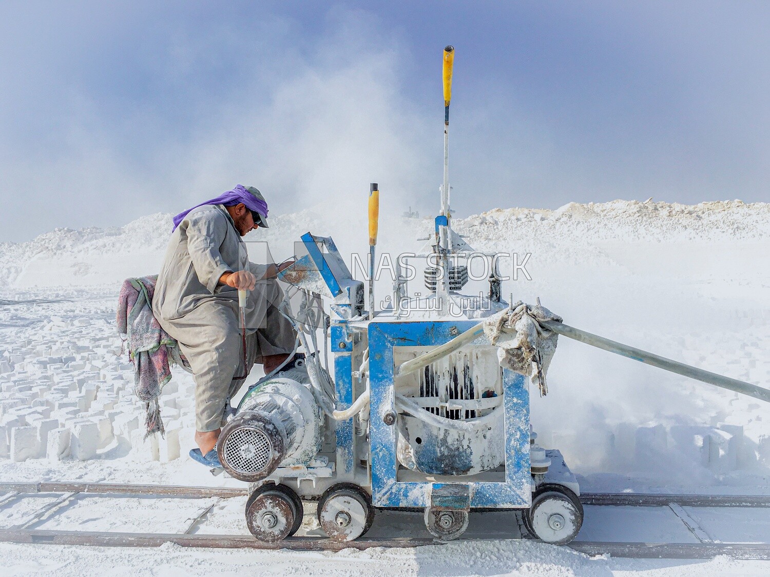 Craftsman working on a white brick machine