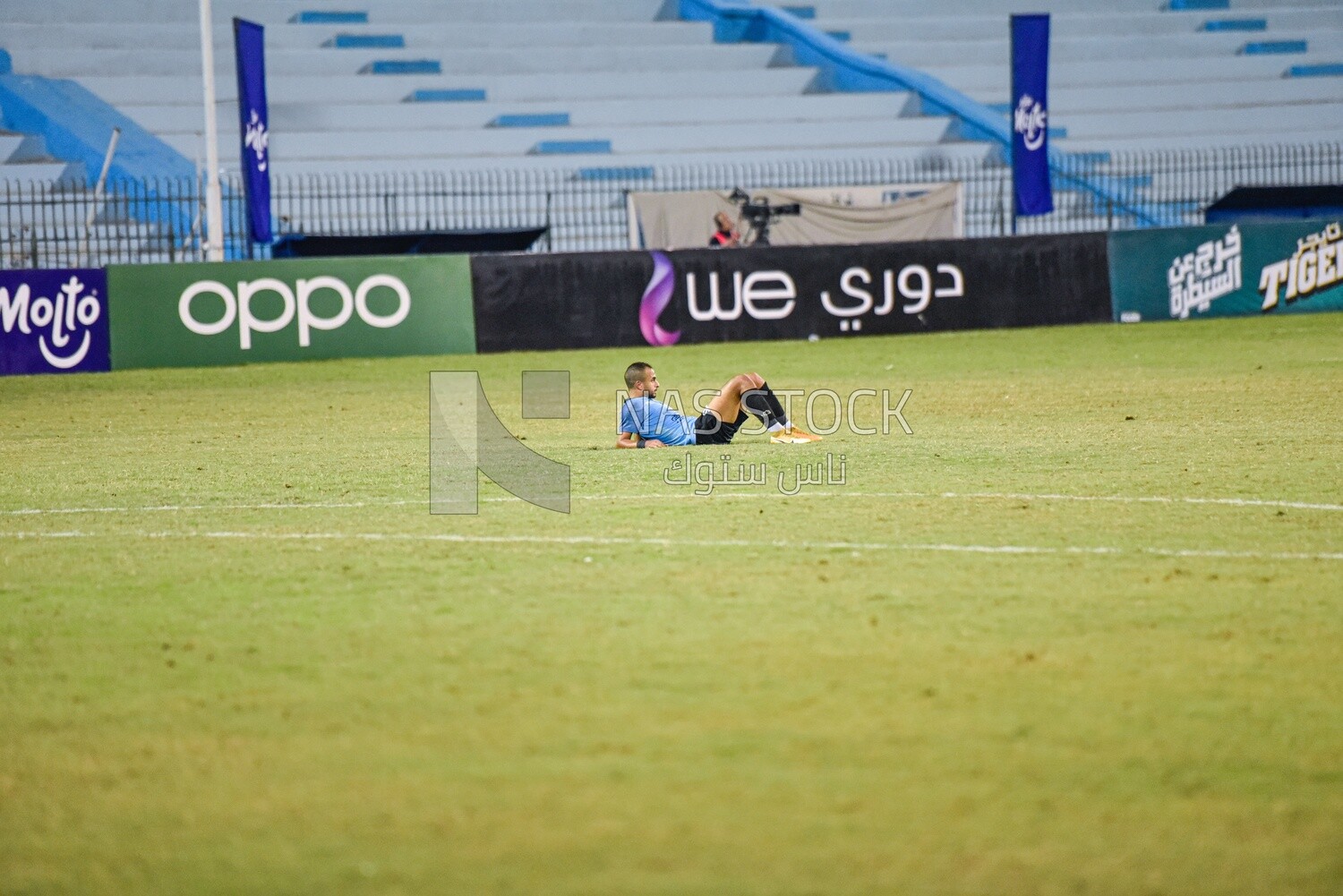 Football player resting on the field after the match