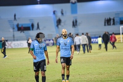 Two players leave the field after the match ends