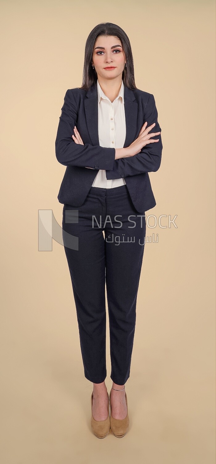 Photo of a businesswoman standing with crossed hands, meeting at the workplace, discussing work tasks, taking notes on the board