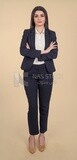 Photo of a businesswoman standing with crossed hands, meeting at the workplace, discussing work tasks, taking notes on the board