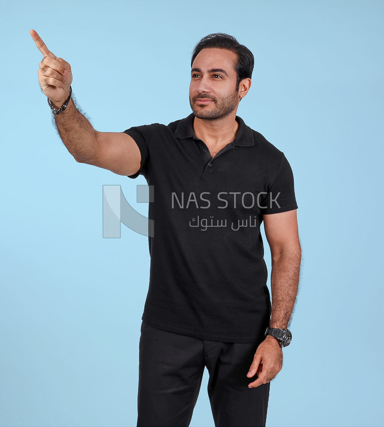 Photo Of a Handsome man Standing and pointing away, Smiling Man, Wearing Casual Clothes Posing In a Light Room Interior, Smiling At the Camera