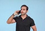 Photo Of a Handsome man Standing and talking in the mobile, Smiling Man, Wearing Casual Clothes Posing In a Light Room Interior, Smiling At the Camera