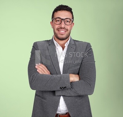 Portrait of a handsome man standing with glasses wearing formal suit with crossed hands, business development and partnerships, business meeting, Model