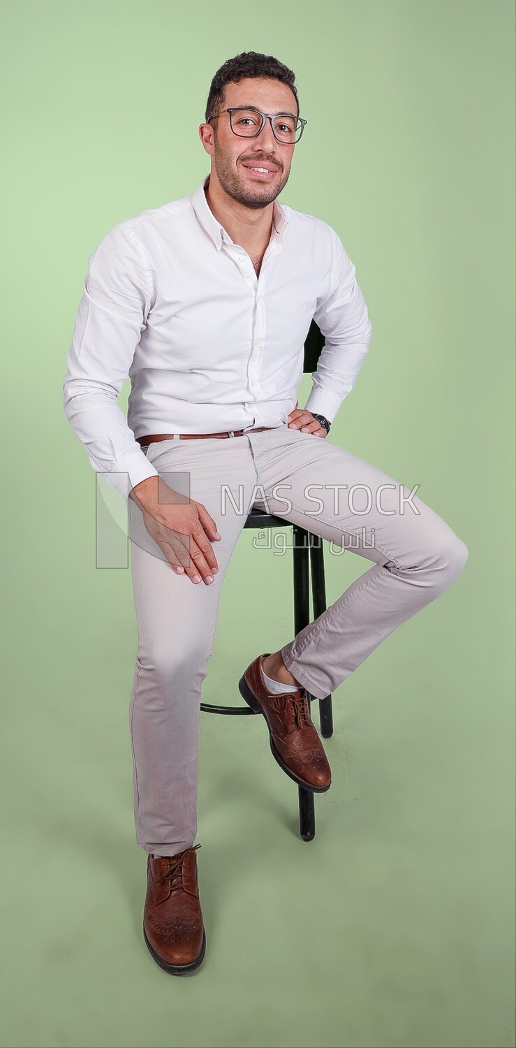 Photo of a handsome man with glasses sitting on a chair, business development and partnerships, business meeting, Model