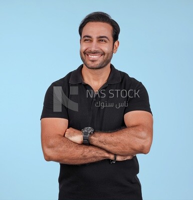 Portrait Of Handsome man Standing with crossed hands, Smiling Man, Wearing Casual Clothes Posing In a Light Room Interior, Smiling At the Camera