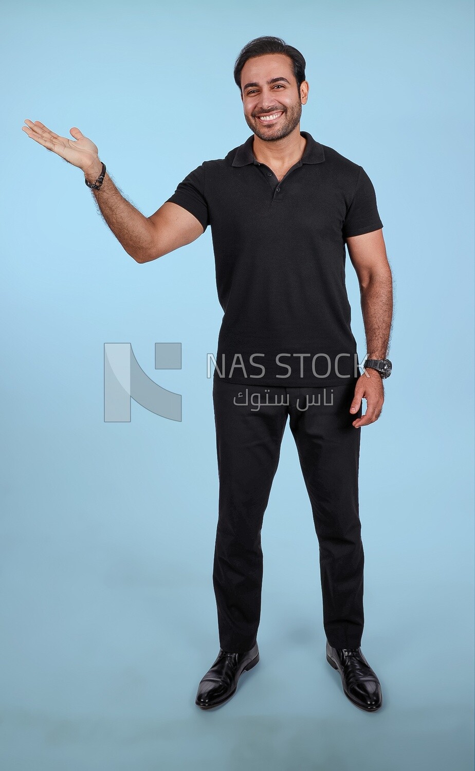 Photo Of a Handsome man Standing and pointing away, Smiling Man, Wearing Casual Clothes Posing In a Light Room Interior, Smiling At the Camera