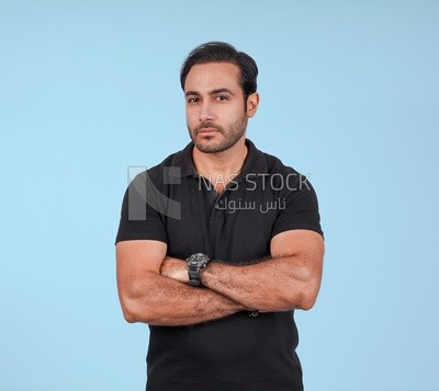 Portrait Of Handsome man Standing with crossed hands, Smiling Man, Wearing Casual Clothes Posing In a Light Room Interior, Smiling At the Camera