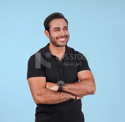 Portrait Of Handsome man Standing with crossed hands, Smiling Man, Wearing Casual Clothes Posing In a Light Room Interior, Smiling At the Camera